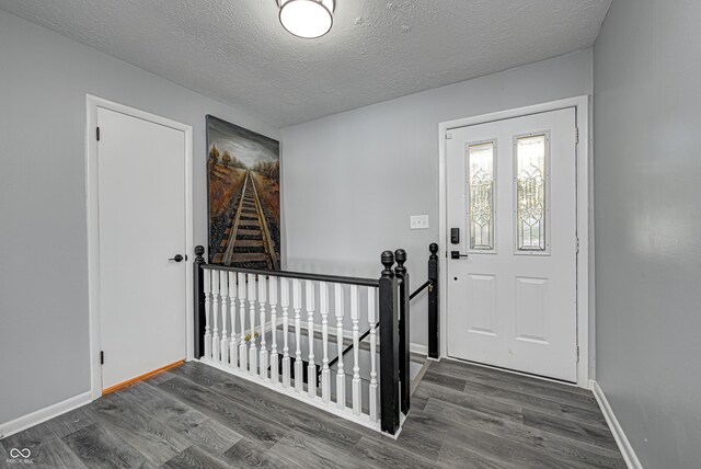 7587 Shady Side Dr, Bloomington, IN 47401 - foyer with baseboards, a textured ceiling, and wood finished floors