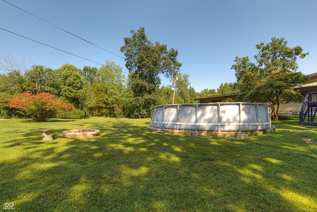 7587 Shady Side Dr, Bloomington, IN 47401 - view of yard with an outdoor pool and a fire pit