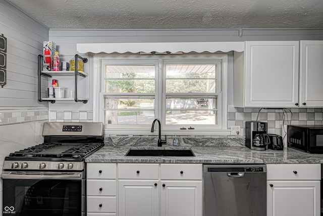 7587 Shady Side Dr, Bloomington, IN 47401 - kitchen with a sink, white cabinetry, appliances with stainless steel finishes, and a healthy amount of sunlight