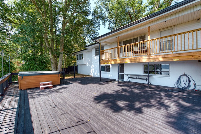 wooden deck featuring a hot tub