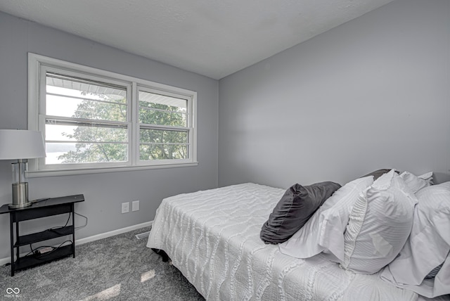 carpeted bedroom featuring lofted ceiling