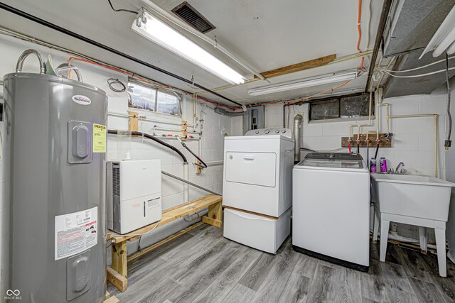 7587 Shady Side Dr, Bloomington, IN 47401 - laundry room with washing machine and clothes dryer, light wood-style flooring, visible vents, laundry area, and water heater