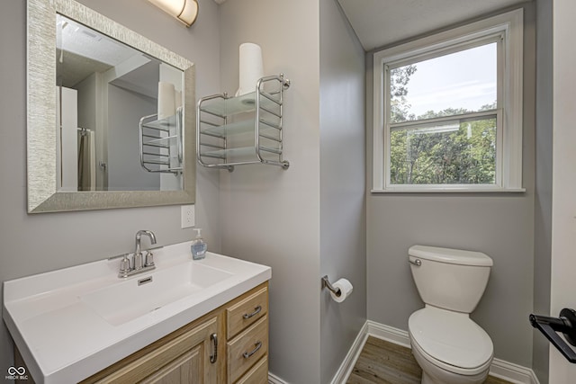 7587 Shady Side Dr, Bloomington, IN 47401 - bathroom with vanity, toilet, a shower with shower curtain, baseboards, and wood finished floors