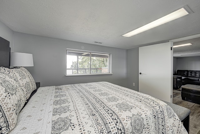 7587 Shady Side Dr, Bloomington, IN 47401 - bedroom featuring visible vents, wood finished floors, and a textured ceiling