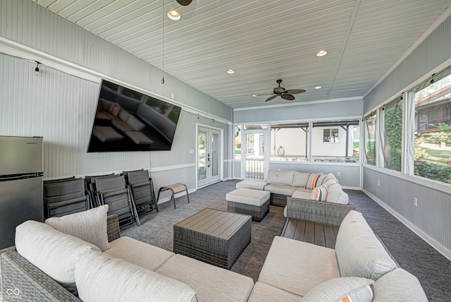 sunroom / solarium featuring ceiling fan