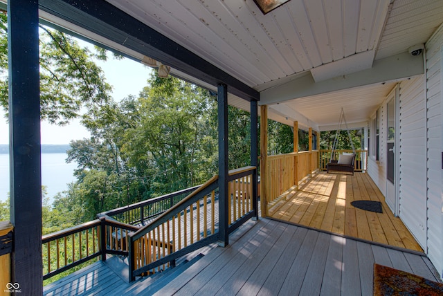 wooden deck featuring a water view