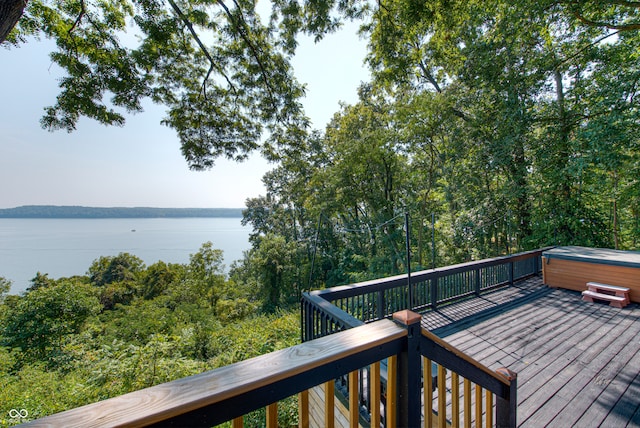 wooden terrace featuring a water view