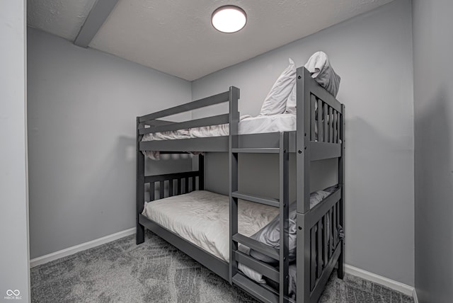 bedroom with a textured ceiling and carpet flooring