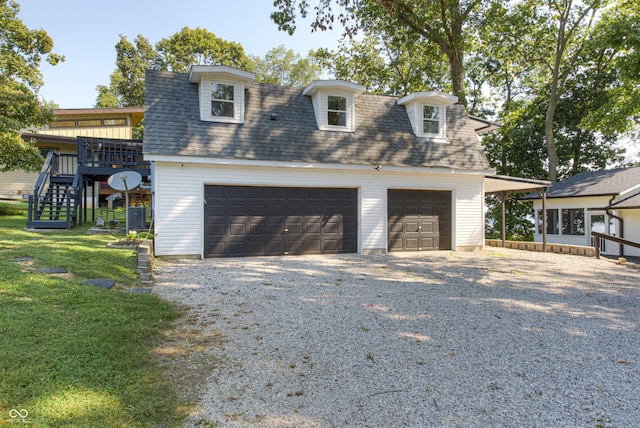 7587 Shady Side Dr, Bloomington, IN 47401 - exterior space with a lawn, a detached garage, stairway, and roof with shingles