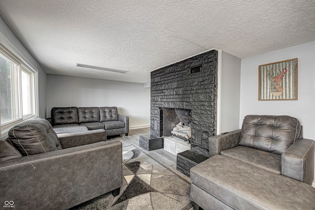 living room with a textured ceiling and light hardwood / wood-style flooring