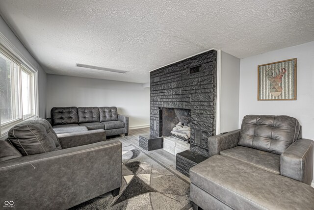 7587 Shady Side Dr, Bloomington, IN 47401 - living room featuring baseboards, a fireplace, wood finished floors, and a textured ceiling