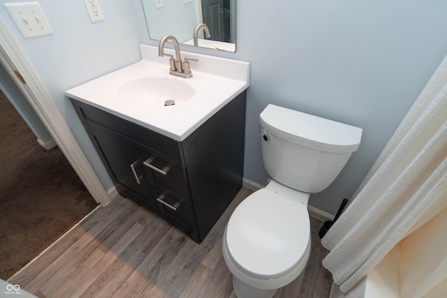 bathroom with vanity, toilet, and wood-type flooring