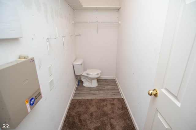 bathroom featuring toilet and wood-type flooring