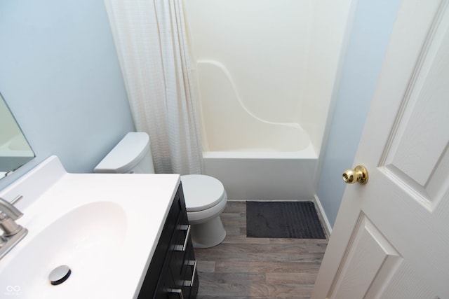 full bathroom featuring vanity, toilet, hardwood / wood-style flooring, and shower / bath combo