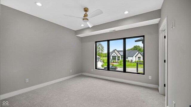 unfurnished room featuring ceiling fan and light colored carpet