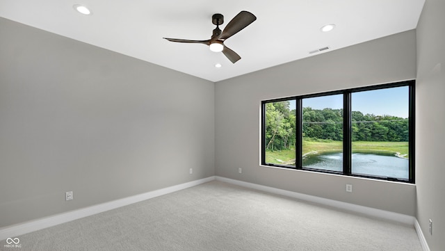 empty room with light colored carpet and ceiling fan