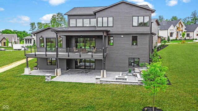 rear view of house with a patio area, ceiling fan, and a yard