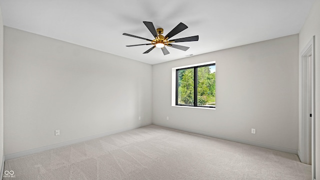 unfurnished room featuring baseboards, a ceiling fan, and light colored carpet