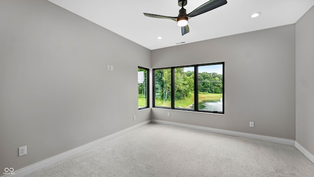 carpeted empty room featuring ceiling fan