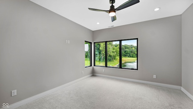 carpeted empty room with a ceiling fan, recessed lighting, visible vents, and baseboards