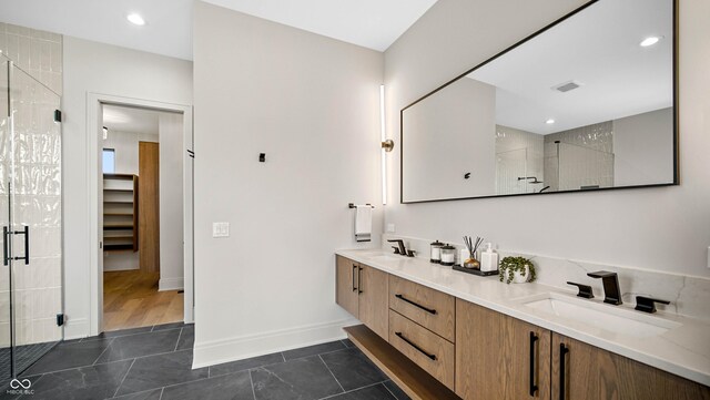 bathroom with vanity, tile patterned floors, and a shower with shower door