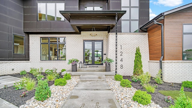 property entrance featuring brick siding