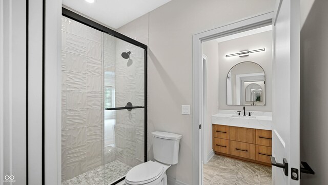 bathroom featuring walk in shower, vanity, and toilet