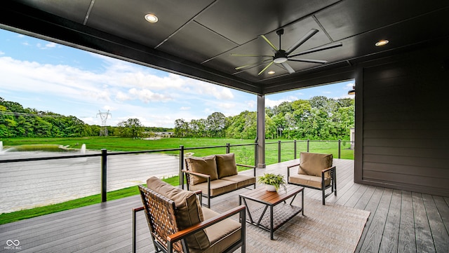 wooden terrace with an outdoor living space, a yard, and ceiling fan