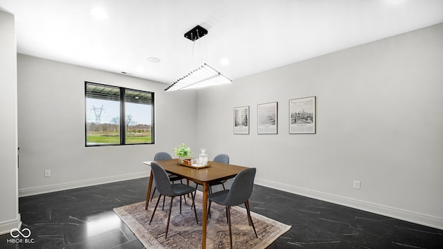 dining room with marble finish floor and baseboards