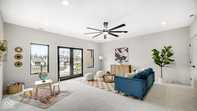 living area with recessed lighting, light carpet, a ceiling fan, visible vents, and french doors