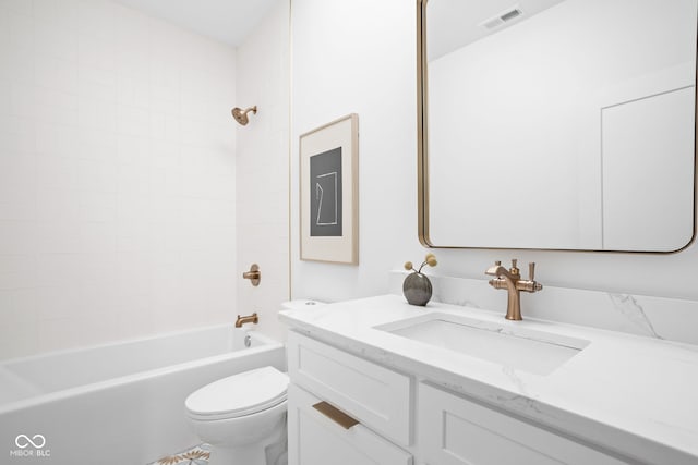 full bathroom with tiled shower / bath combo, vanity, and toilet