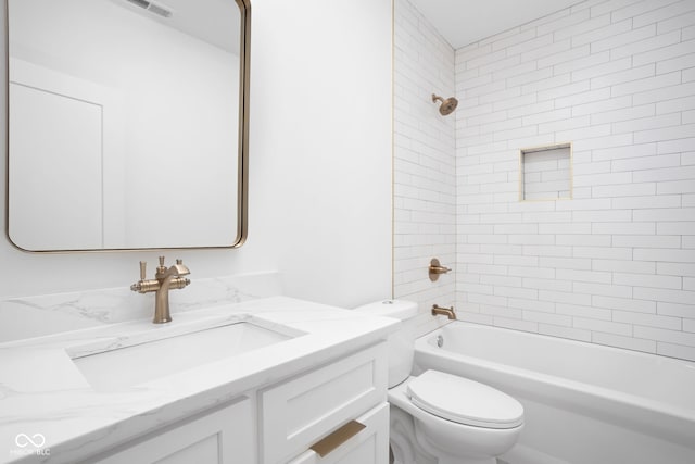 full bathroom with vanity, toilet, and tiled shower / bath