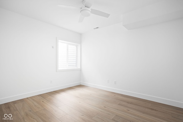 spare room featuring light wood-type flooring and ceiling fan