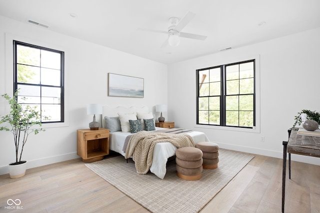 bedroom with ceiling fan and light hardwood / wood-style floors