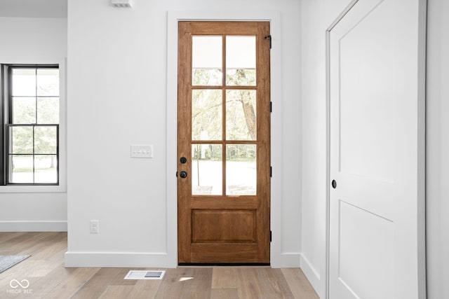 doorway to outside with plenty of natural light and light wood-type flooring