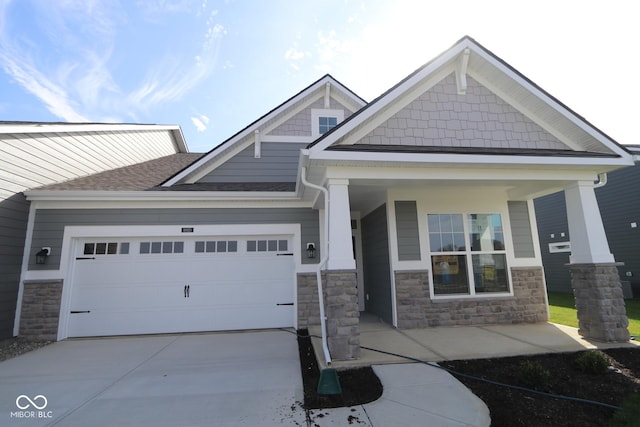 craftsman-style home featuring a porch and a garage