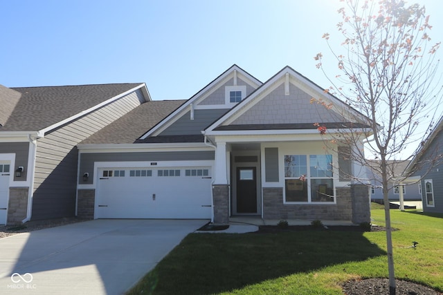 craftsman-style home with a front yard and a garage