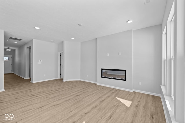 unfurnished living room with light hardwood / wood-style flooring