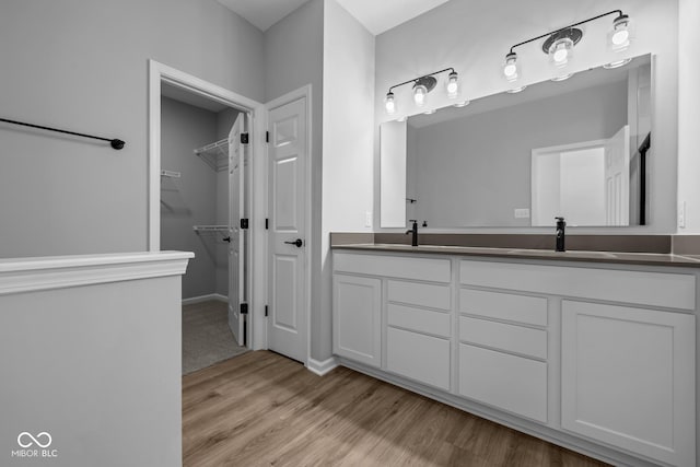 bathroom with hardwood / wood-style floors and vanity