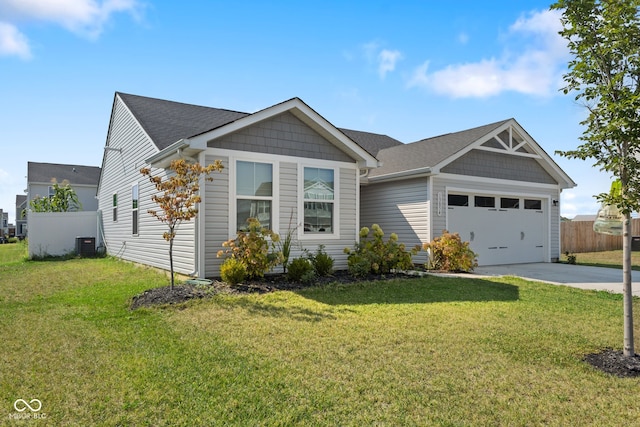 view of front of property featuring cooling unit, a garage, and a front lawn