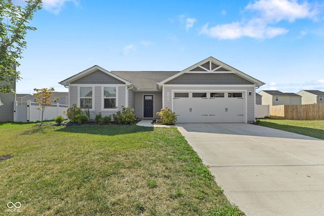 view of front of property featuring a garage and a front lawn