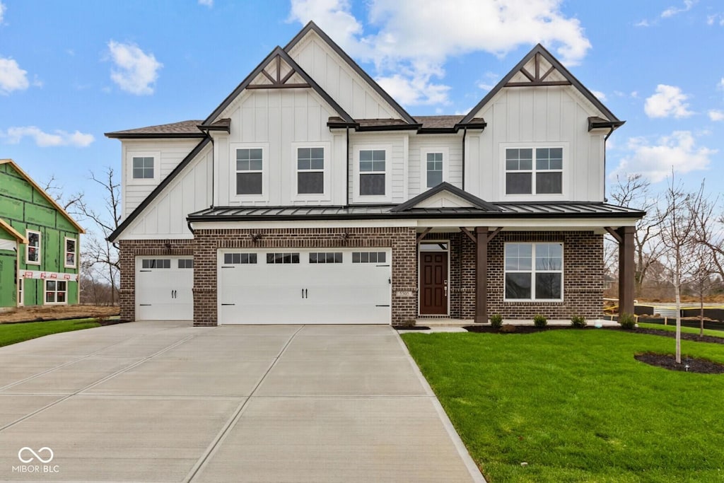 view of front of home featuring a garage and a front yard