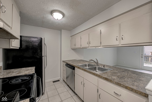 kitchen featuring white cabinets, light tile patterned floors, stainless steel appliances, sink, and a textured ceiling