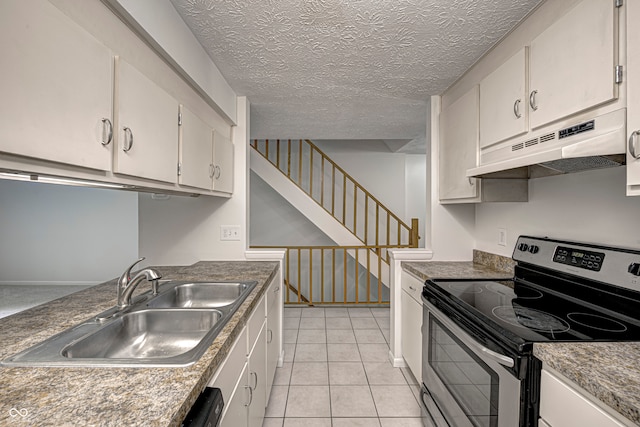 kitchen with electric stove, white cabinetry, a textured ceiling, light tile patterned floors, and sink