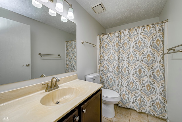 bathroom with curtained shower, tile patterned floors, toilet, vanity, and a textured ceiling