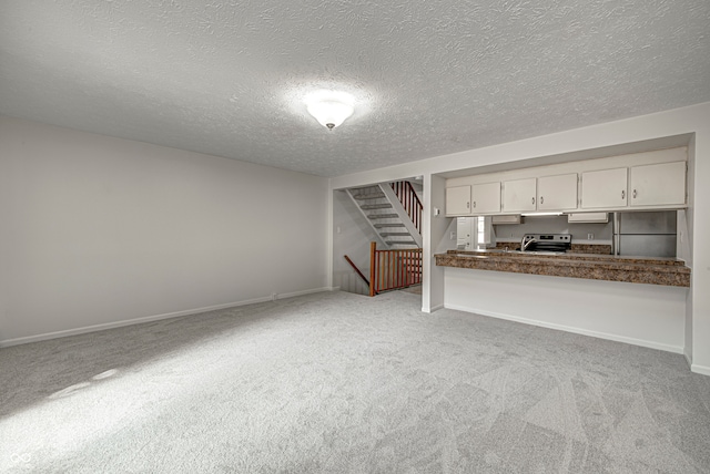 interior space featuring a textured ceiling and carpet floors