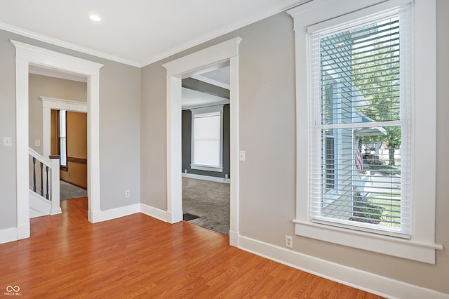 unfurnished room with wood-type flooring and crown molding