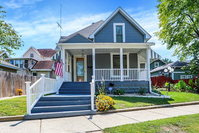 bungalow with a porch and a front yard