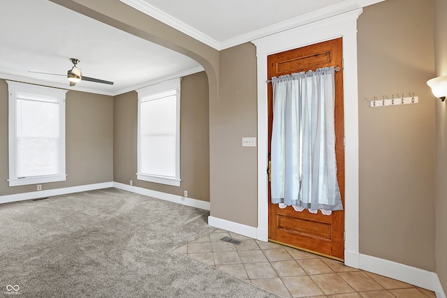 tiled foyer entrance with ornamental molding