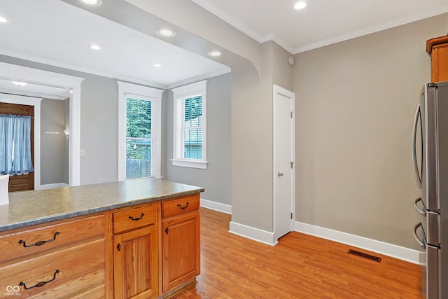 kitchen featuring stainless steel fridge, light hardwood / wood-style floors, and crown molding